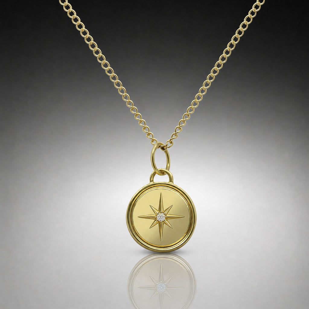Gold necklace with a star-shaped pendant on a reflective surface